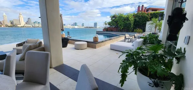 a view of balcony with chairs and a potted plant