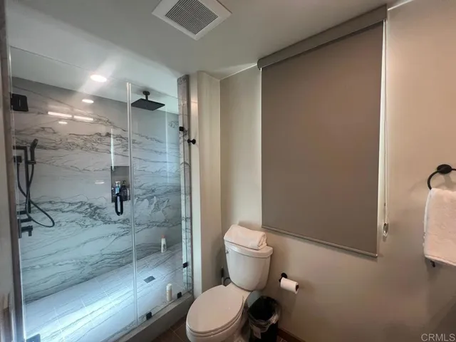 a bathroom with a toilet and a shower