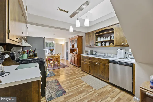 a large living room with stainless steel appliances granite countertop furniture and a kitchen view