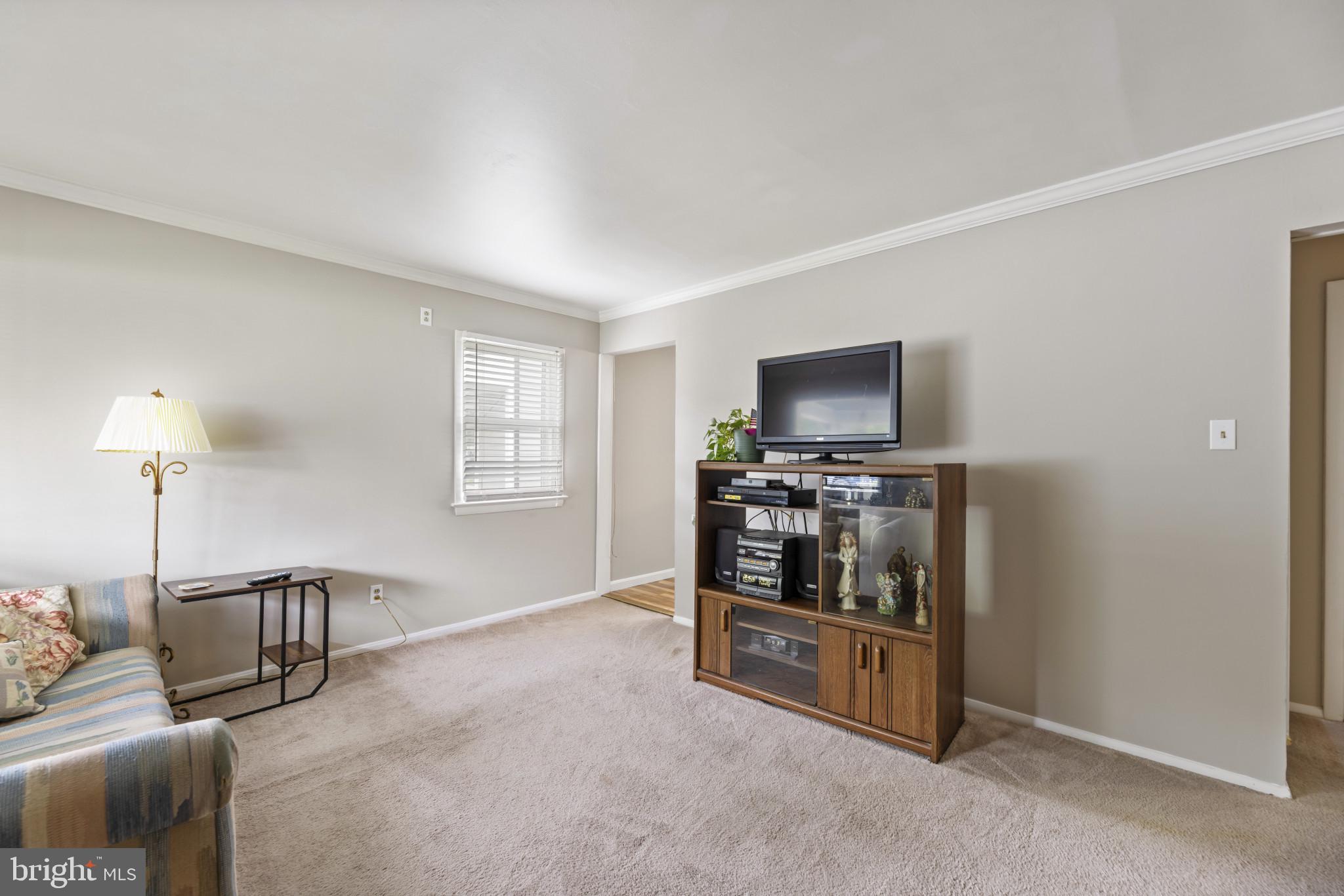 118 Mace Street Manassas Park, VA 20111 - Photo 4 of 25 a living room with furniture and a flat screen tv