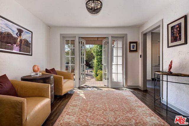 a living room with furniture and a floor to ceiling window