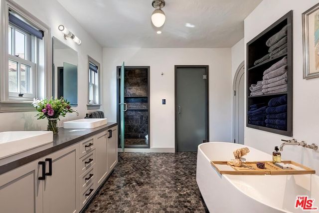 a bathroom with a double vanity sink and a mirror