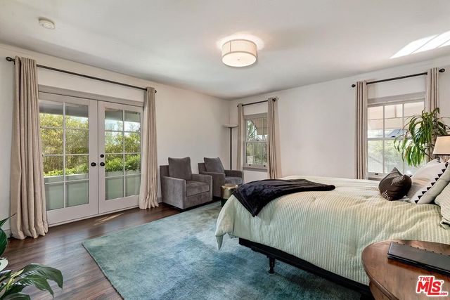 a bedroom with a bed and large window