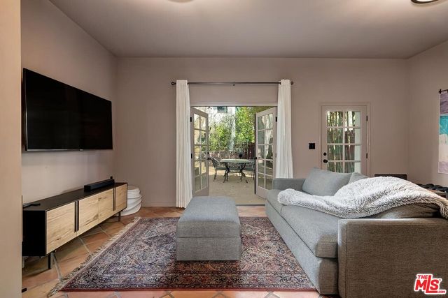 a kitchen with stainless steel appliances a sink a stove a table and chairs