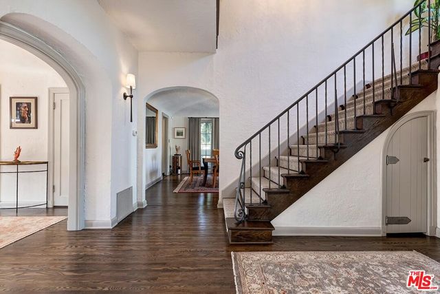 a view of entryway and hall with wooden floor
