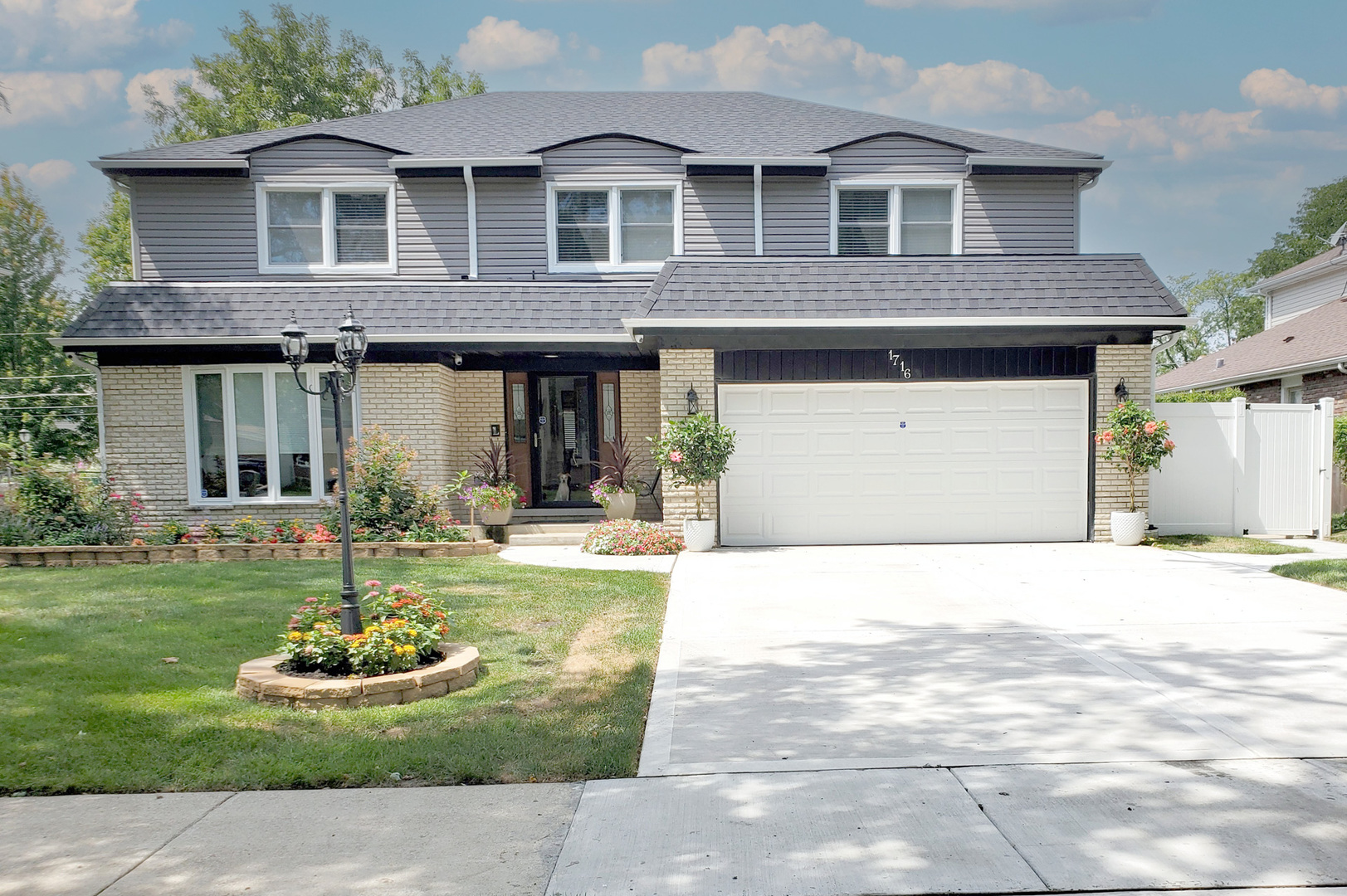 a front view of a house with a garden and patio