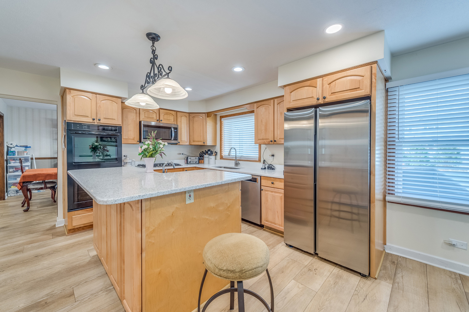 1716 Beech Road Mount Prospect, IL 60056 - Photo 7 of 28 a kitchen with stainless steel appliances granite countertop a refrigerator a stove and a sink with wooden floor