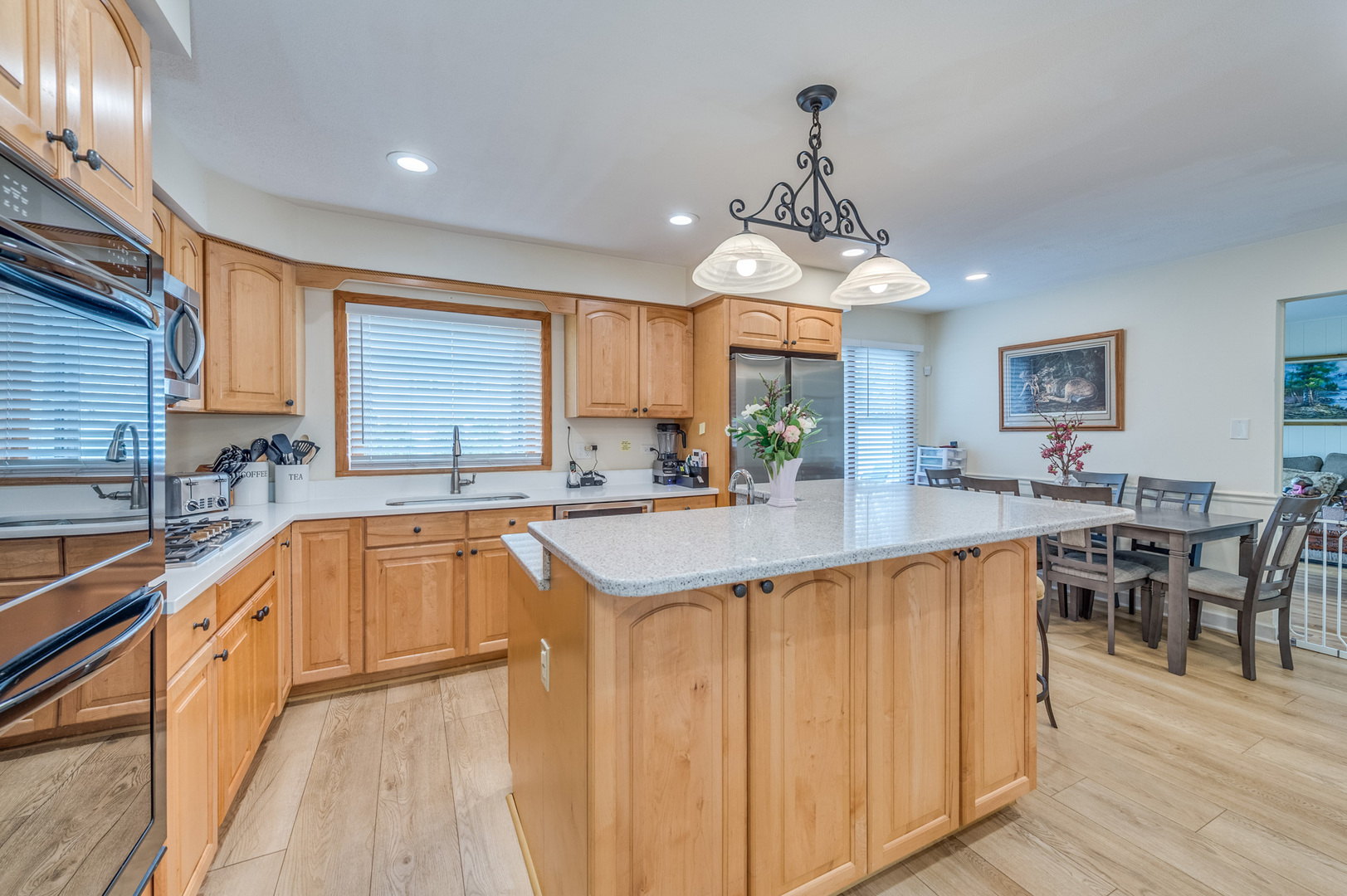 1716 Beech Road Mount Prospect, IL 60056 - Photo 8 of 28 a large kitchen with stainless steel appliances granite countertop a sink dishwasher stove and wooden cabinets with wooden floor
