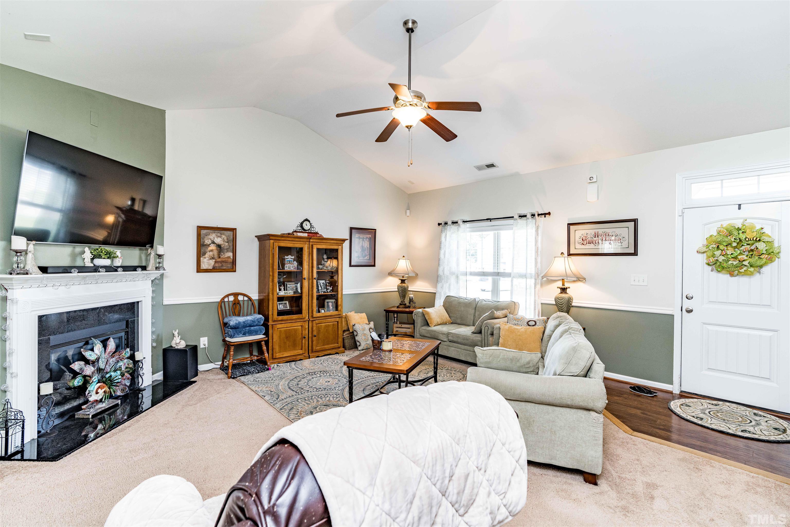 180 Crane Way Bunnlevel, NC 28323 - Photo 14 of 26 a living room with fireplace furniture and a flat screen tv