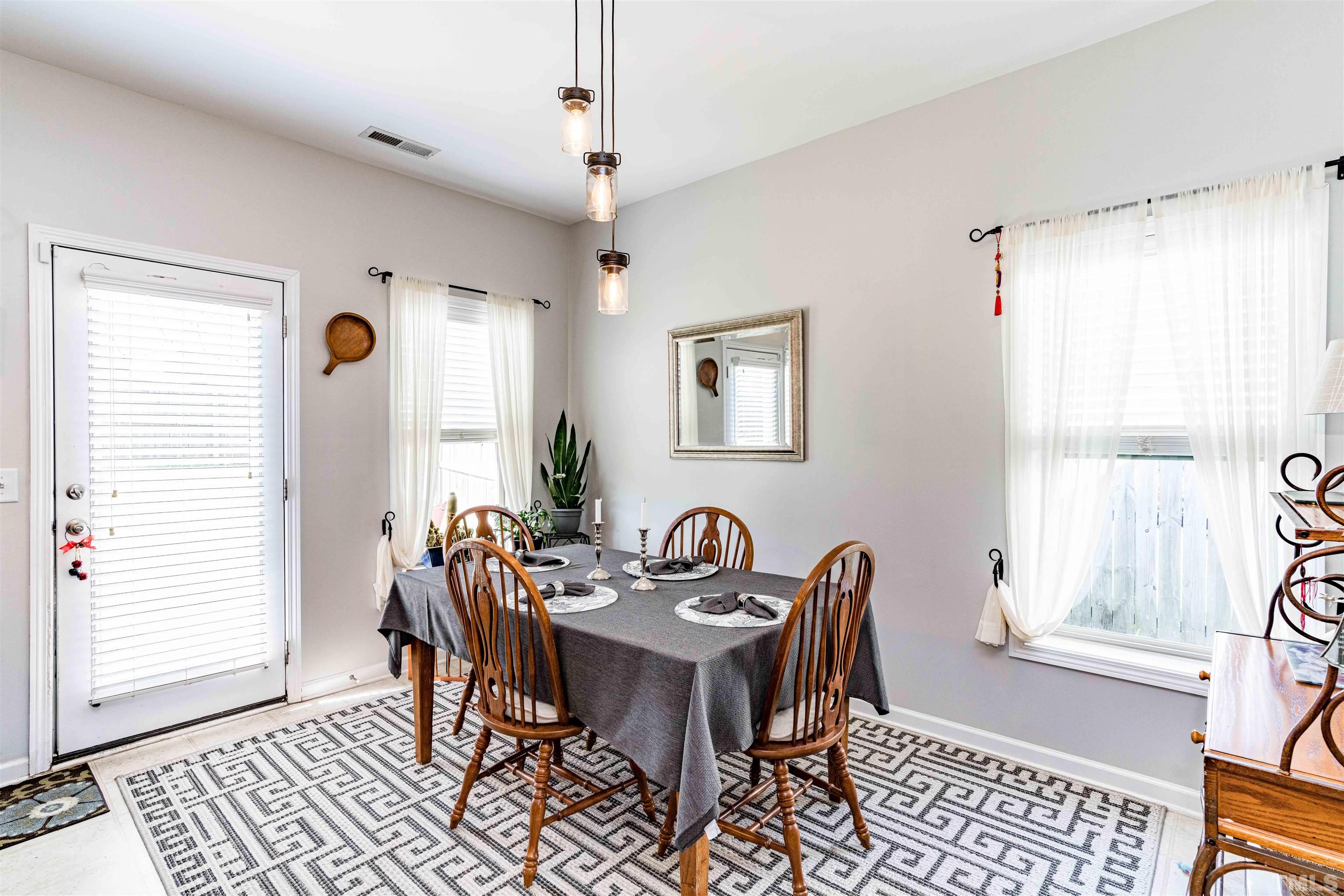180 Crane Way Bunnlevel, NC 28323 - Photo 16 of 26 a view of a a dining room with furniture window and wooden floor