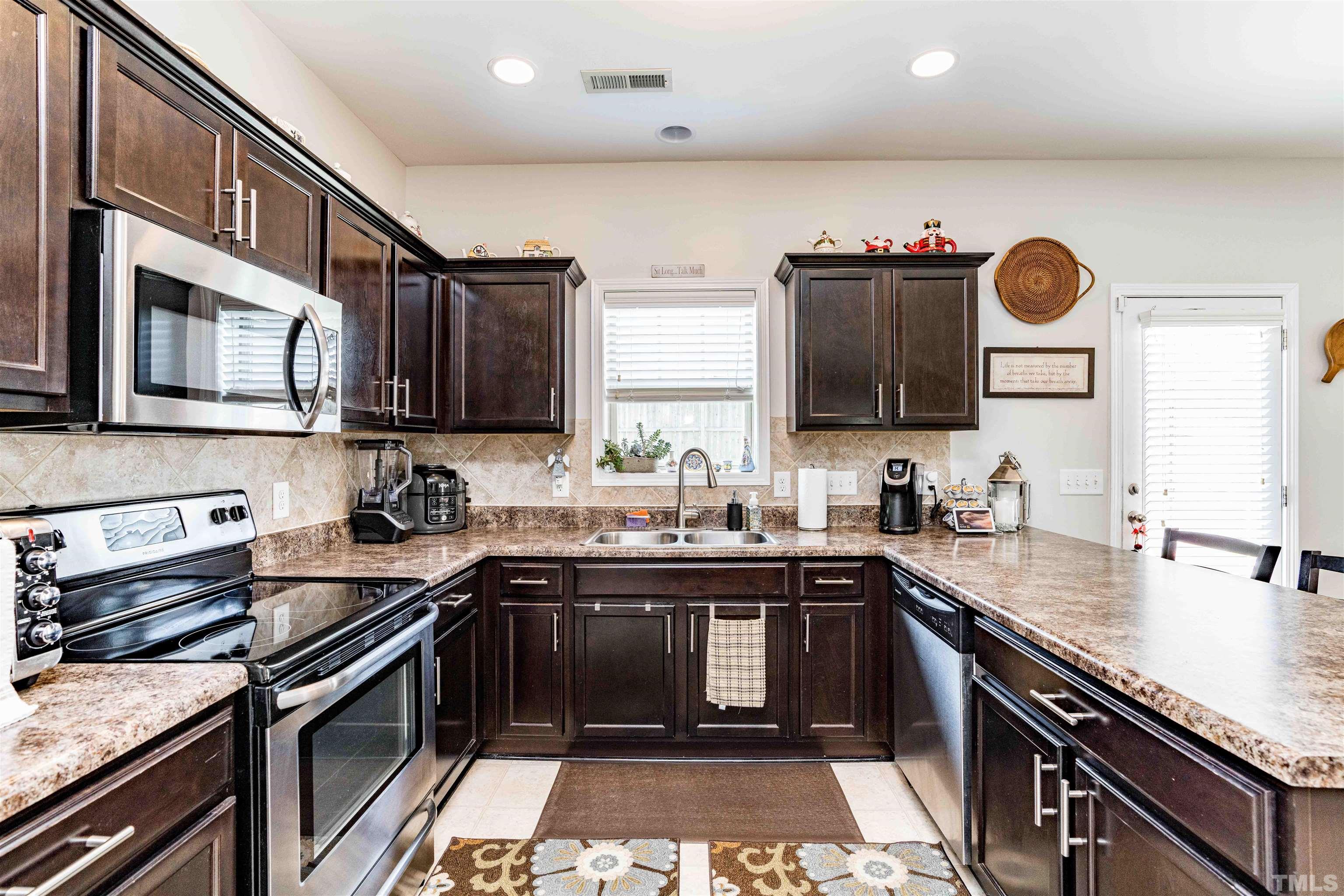 180 Crane Way Bunnlevel, NC 28323 - Photo 20 of 26 a kitchen with a sink stove top oven and microwave