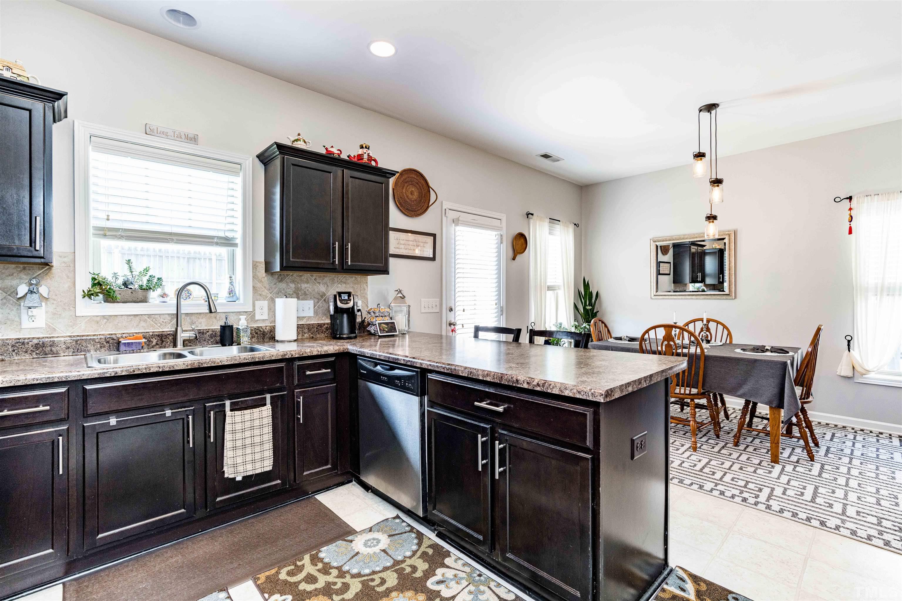 180 Crane Way Bunnlevel, NC 28323 - Photo 21 of 26 a kitchen with a sink stove and microwave