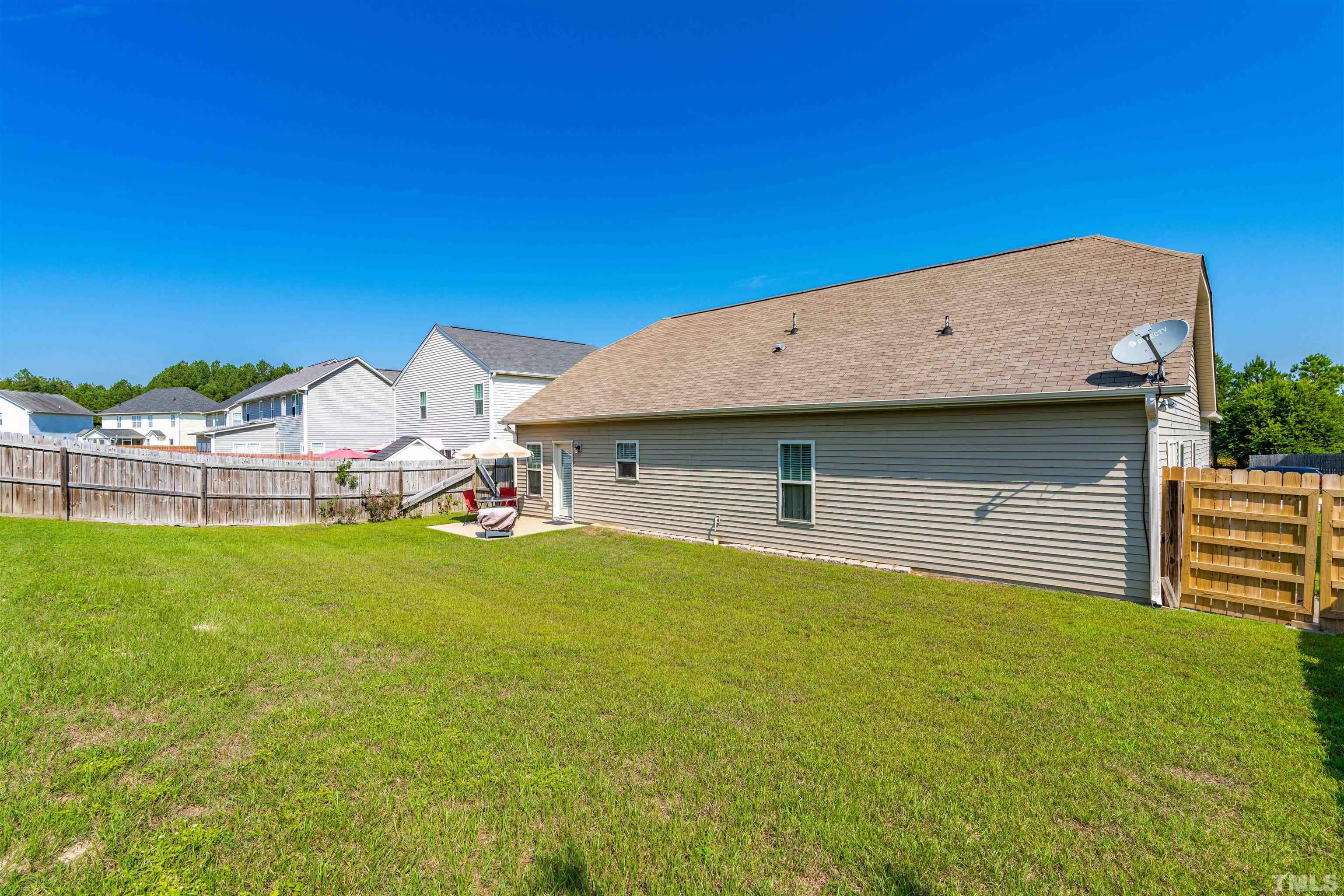 180 Crane Way Bunnlevel, NC 28323 - Photo 25 of 26 a view of a house with a backyard and a garage