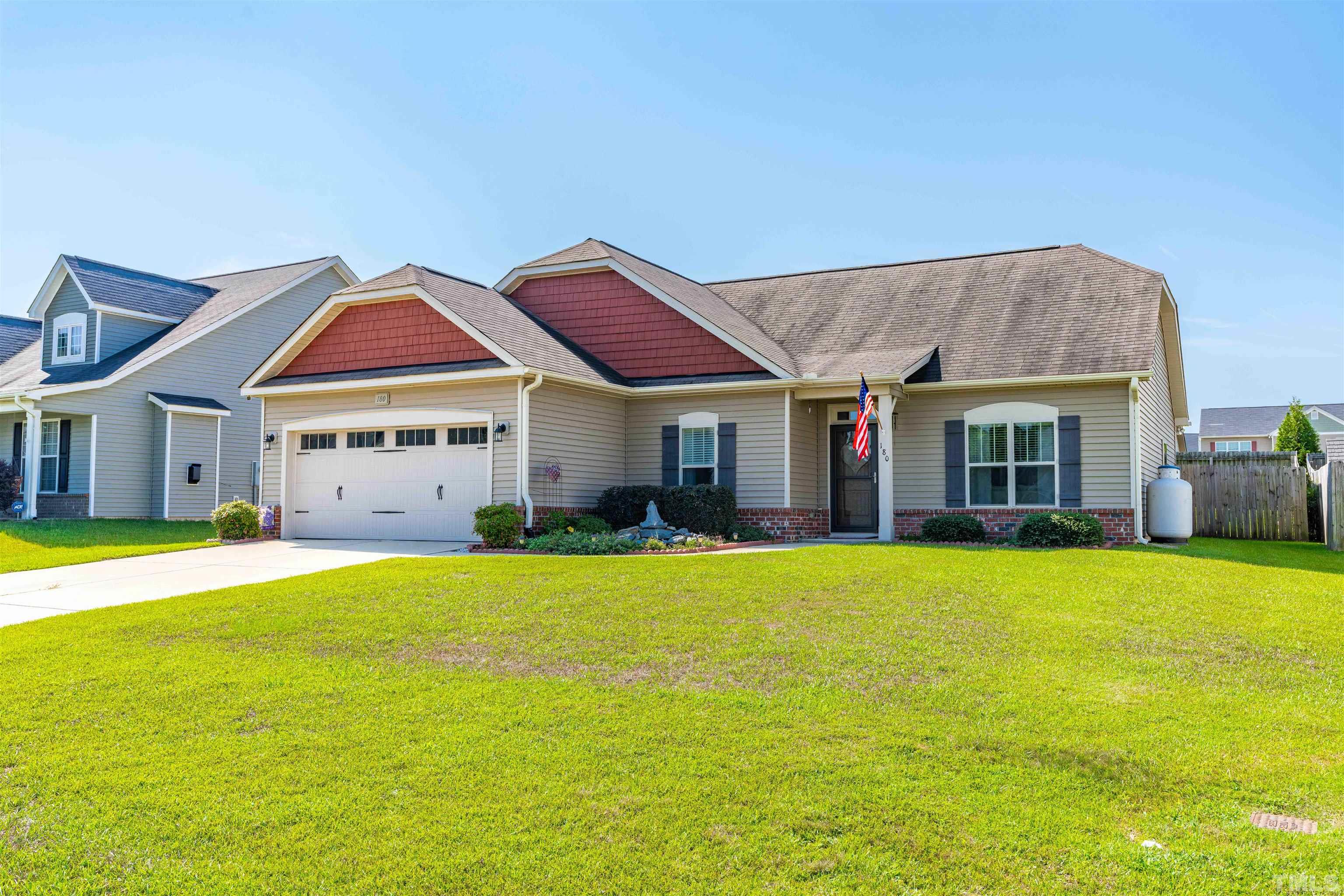 180 Crane Way Bunnlevel, NC 28323 - Photo 4 of 26 a front view of a house with a yard and porch