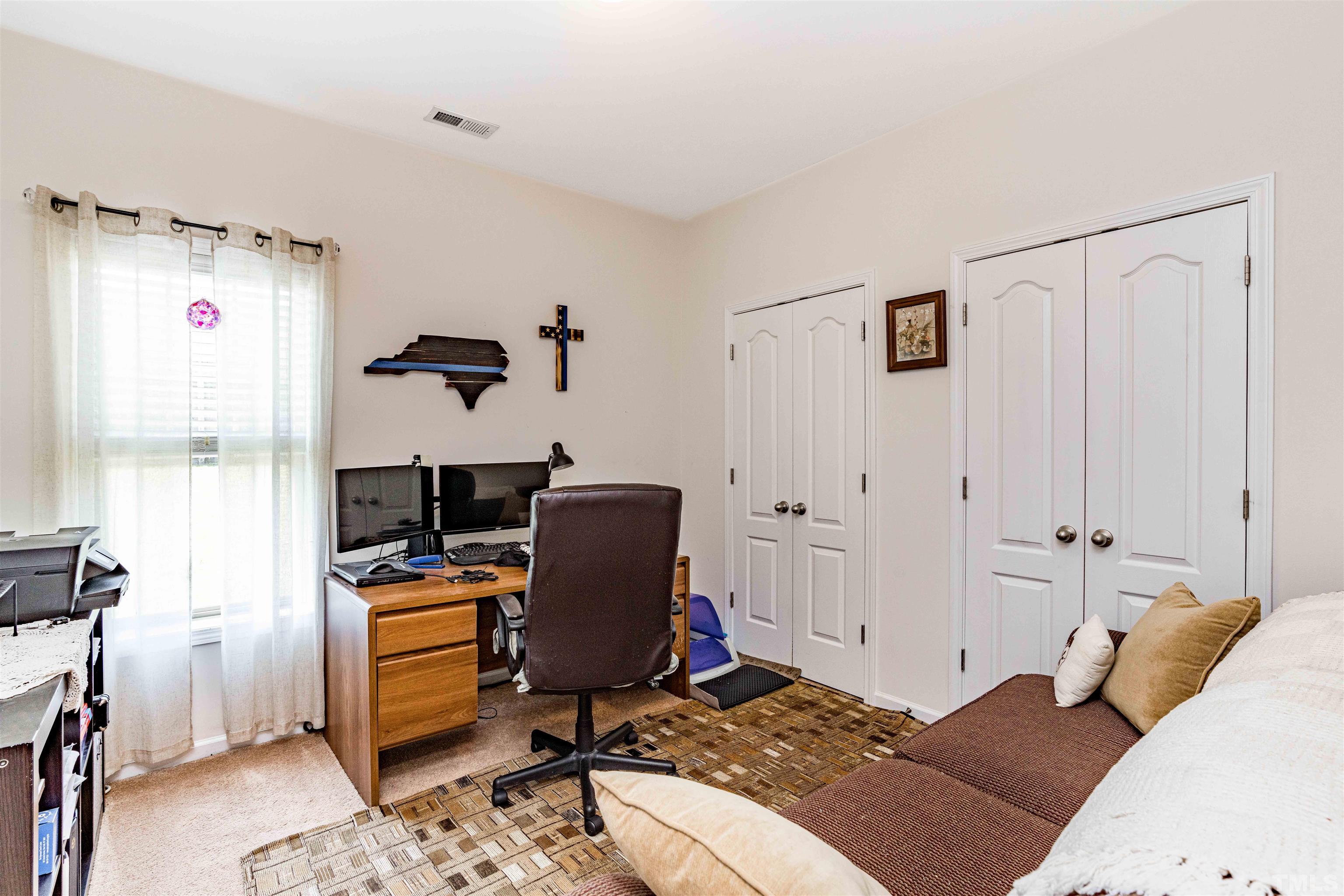 180 Crane Way Bunnlevel, NC 28323 - Photo 5 of 26 a bedroom with a bed and a desk