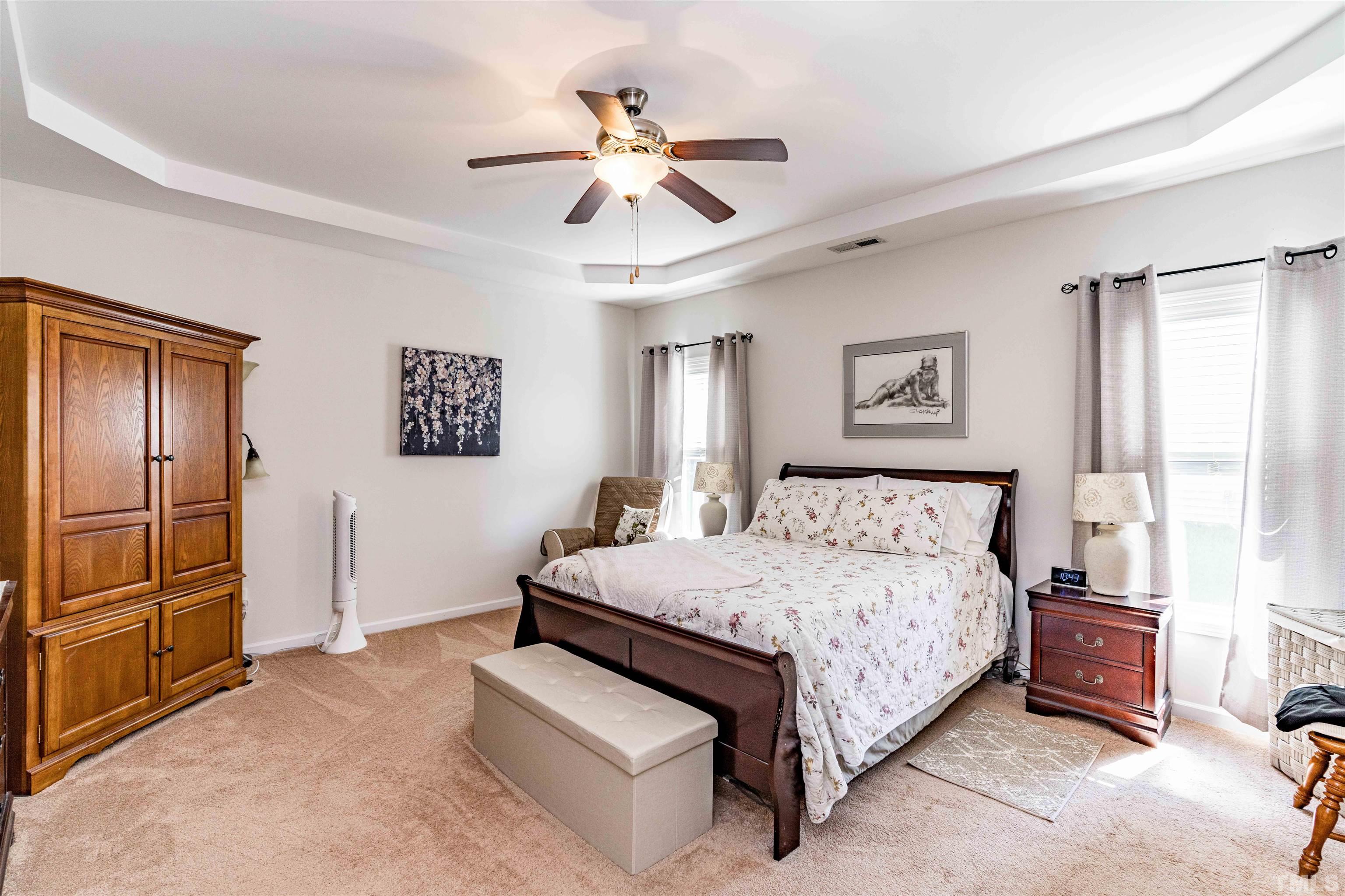 180 Crane Way Bunnlevel, NC 28323 - Photo 6 of 26 a bedroom with a bed and a chandelier