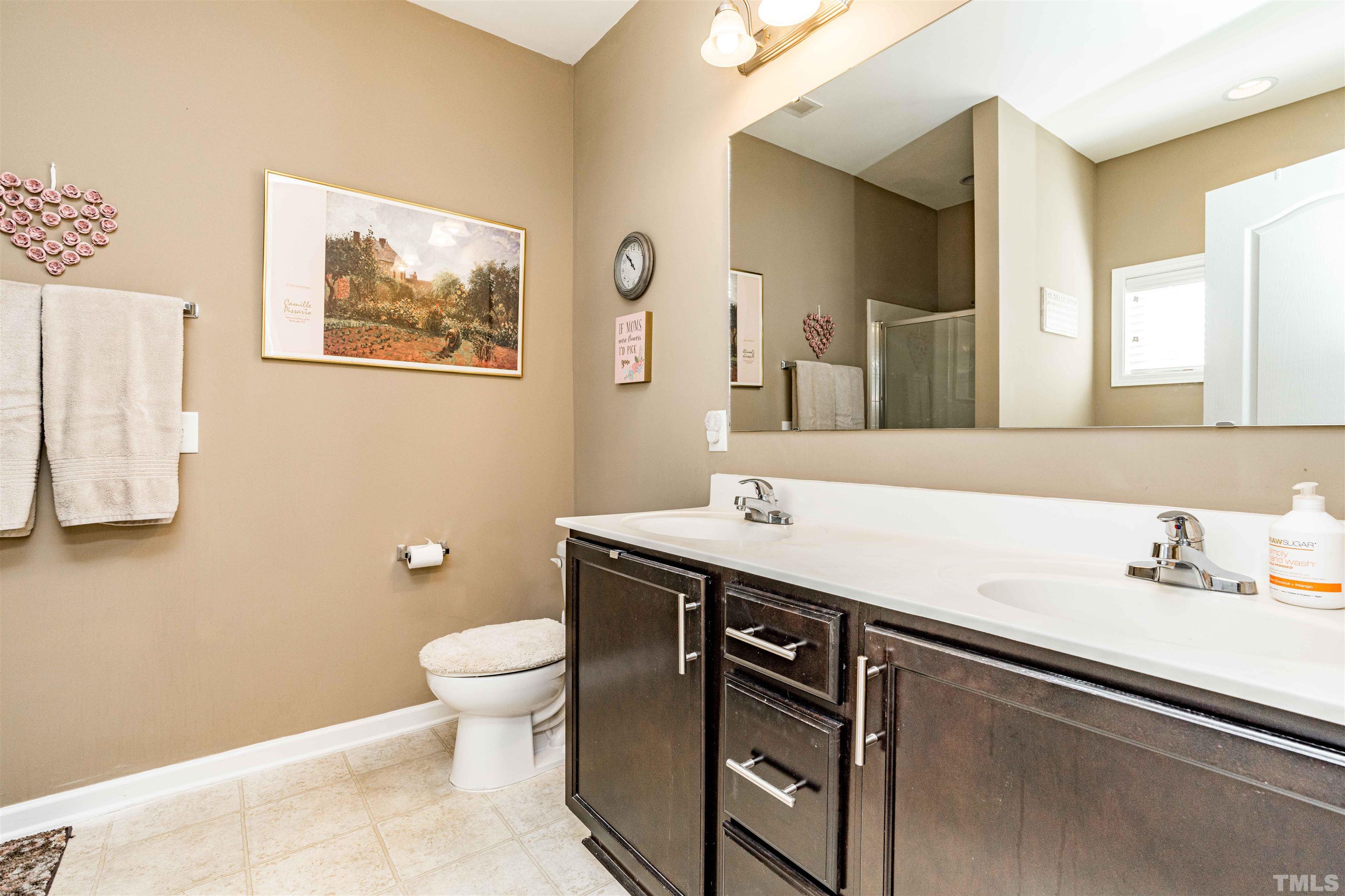 180 Crane Way Bunnlevel, NC 28323 - Photo 8 of 26 a bathroom with a sink a toilet and mirror
