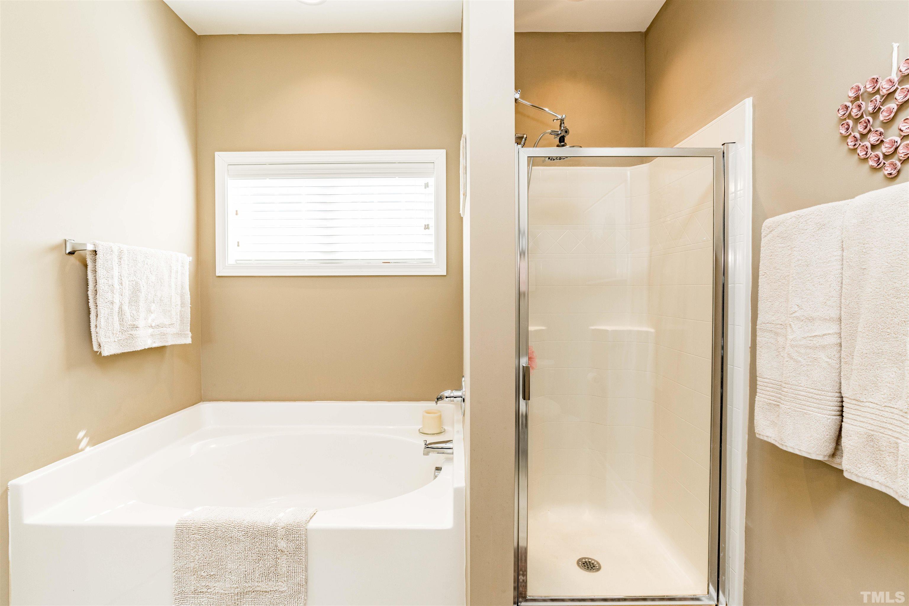 180 Crane Way Bunnlevel, NC 28323 - Photo 9 of 26 a bathroom with a bathtub and a shower