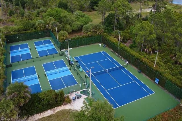 a view of a tennis ground with a large pool of the house