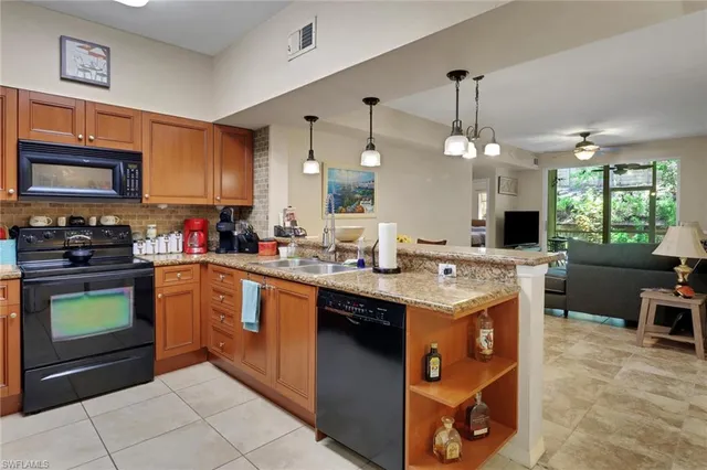 a kitchen with a sink stove and microwave