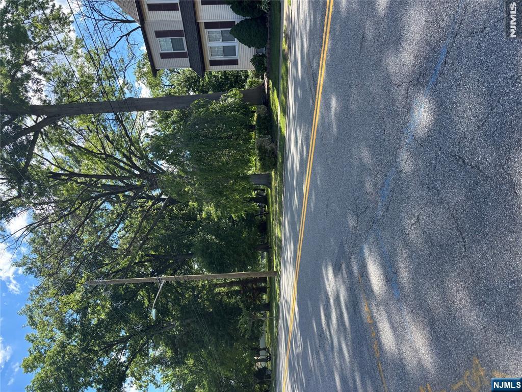 382 Riverside Avenue Rutherford, NJ 07070 - Photo 5 of 29 a view of a house with a big yard and large trees