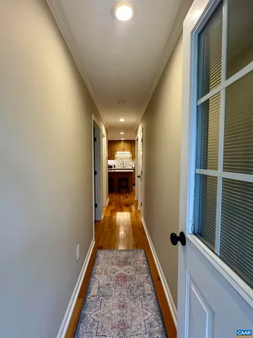 a view of a room with wooden floor