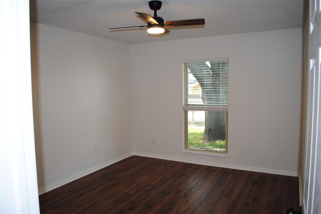 5241 Reed Drive The Colony, TX 75056 - Photo 18 of 26 Bedroom featuring wood-finish flooring, white baseboards, a ceiling fan with integrated lighting, and a window with blinds