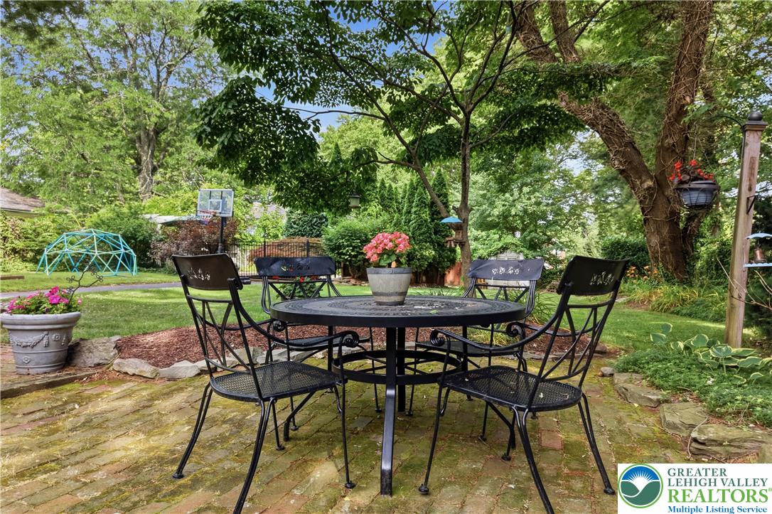 2014 Linden Street Bethlehem, PA 18017 - Photo 70 of 85 A private, brick-paved patio offers a tranquil outdoor retreat amidst lush greenery.