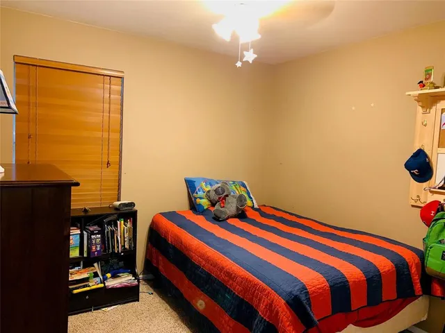 a bedroom with a bed and a dresser