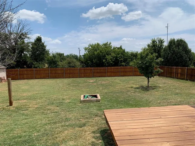 a view of a backyard with wooden floor