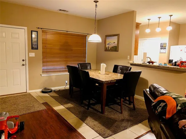 a dining room with furniture and wooden floor