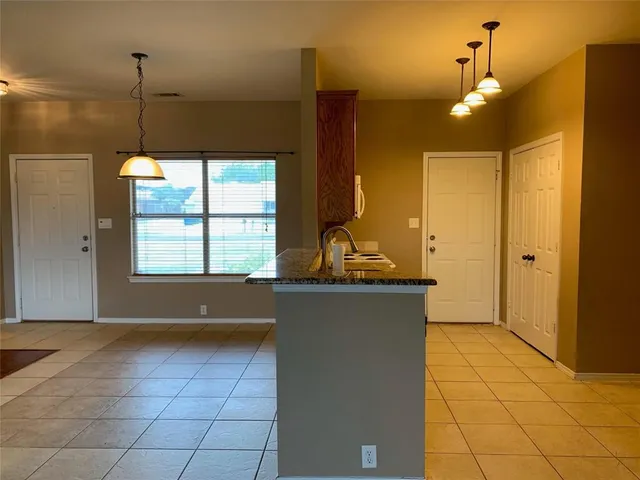 a view of kitchen with window and cabinets