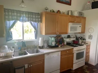 a kitchen with a sink cabinets and window