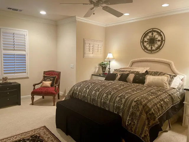 a bedroom with a bed and wall paintings