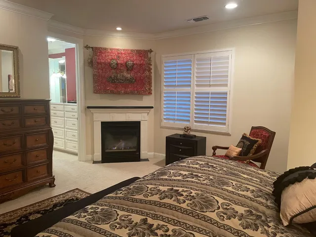 a bedroom with a bed and a fireplace