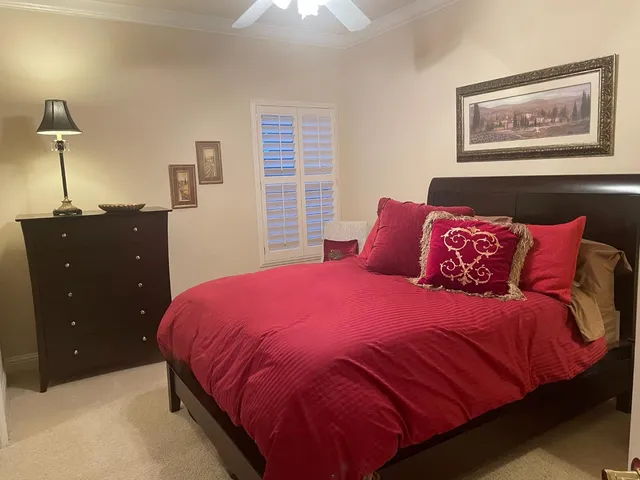 a bedroom with a bed and a painting on the wall