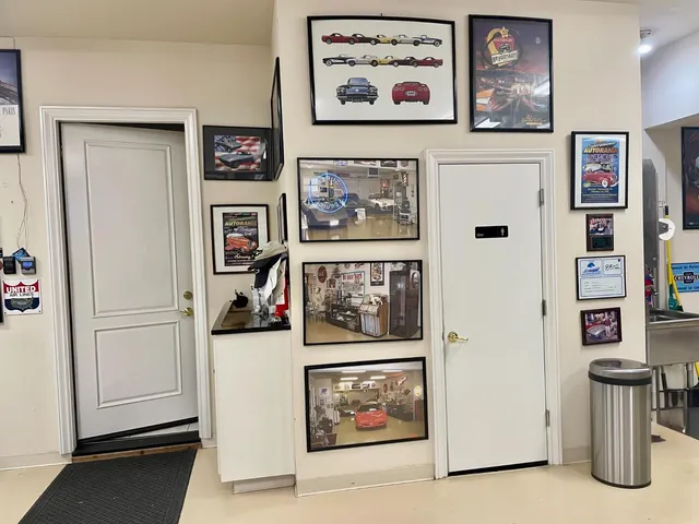 a view of a hallway with painting and a refrigerator
