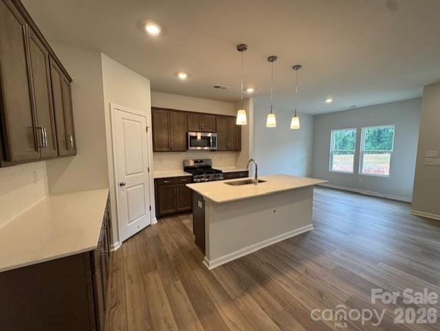 206 Rodeo Drive Shelby, NC 28150 - Photo 6 of 19 a large kitchen with a center island wooden floor and stainless steel appliances