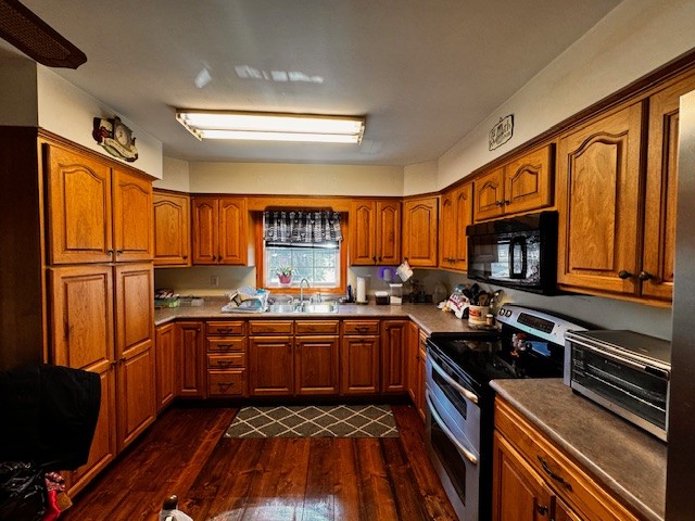 6910 Rowe Gap Road Belvidere, TN 37306 - Photo 4 of 30 a kitchen with stainless steel appliances granite countertop a stove top oven a sink dishwasher a refrigerator and cabinets with wooden floor