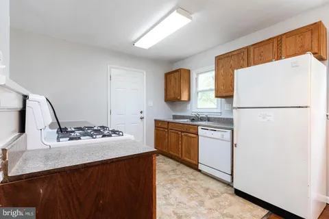 a kitchen with a refrigerator and a sink