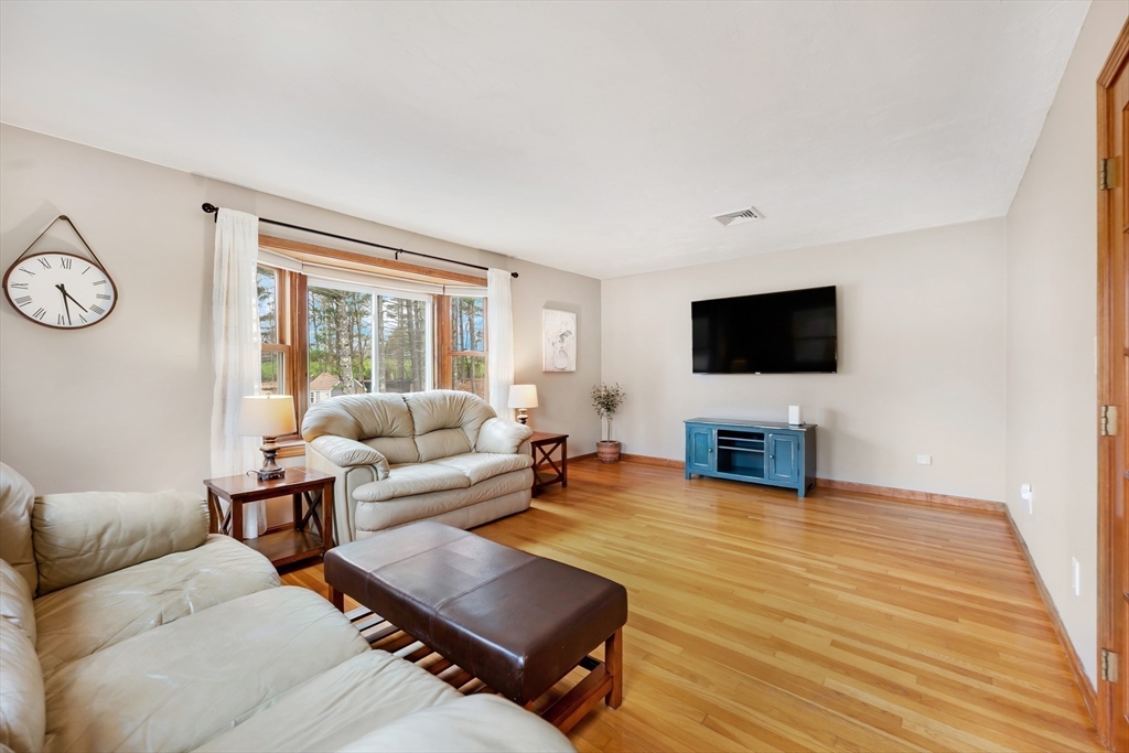 206 Olde Forge Road Hanover, MA 02339 - Photo 12 of 42 a living room with furniture and a flat screen tv