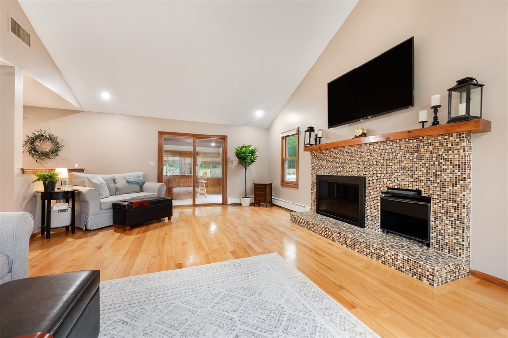 206 Olde Forge Road Hanover, MA 02339 - Photo 14 of 42 a living room with furniture a flat screen tv and a fireplace