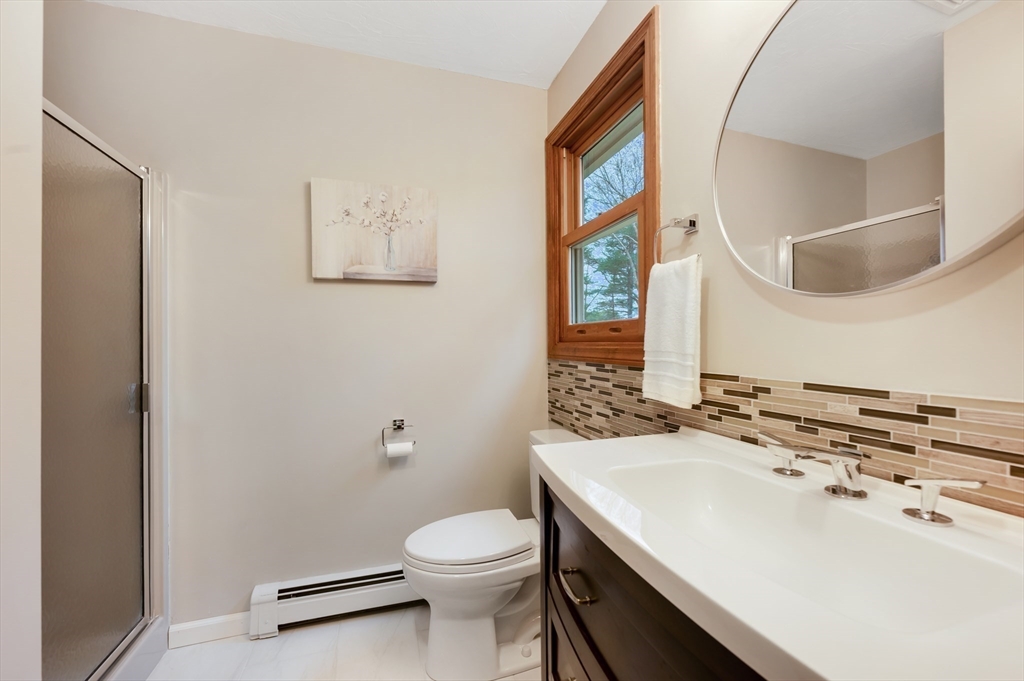 206 Olde Forge Road Hanover, MA 02339 - Photo 22 of 42 a bathroom with a sink a toilet and mirror