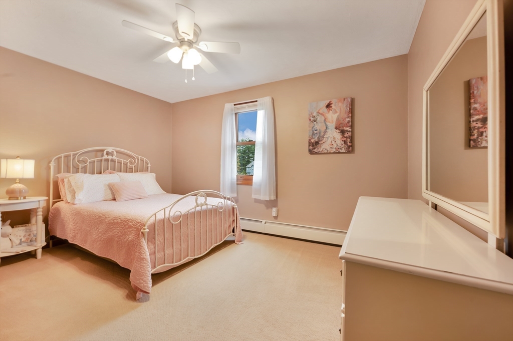 206 Olde Forge Road Hanover, MA 02339 - Photo 24 of 42 a bedroom with a bed and a chandelier