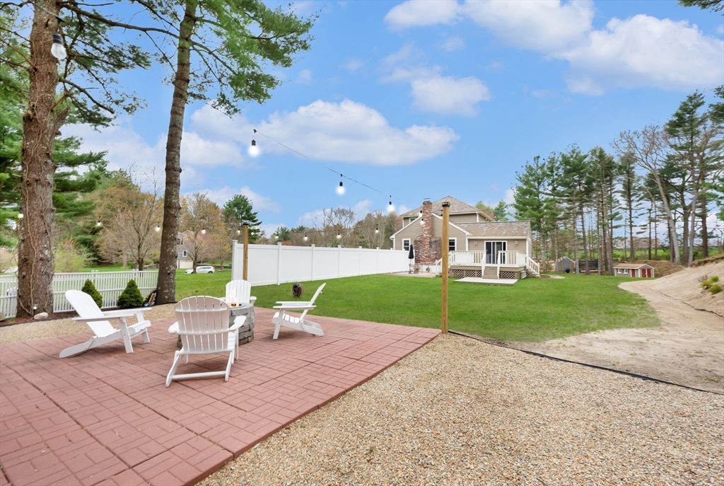 206 Olde Forge Road Hanover, MA 02339 - Photo 34 of 42 a view of a patio with a table and chairs next to a yard