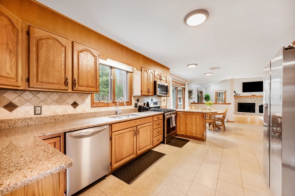 206 Olde Forge Road Hanover, MA 02339 - Photo 6 of 42 a large kitchen with stainless steel appliances granite countertop a sink and cabinets
