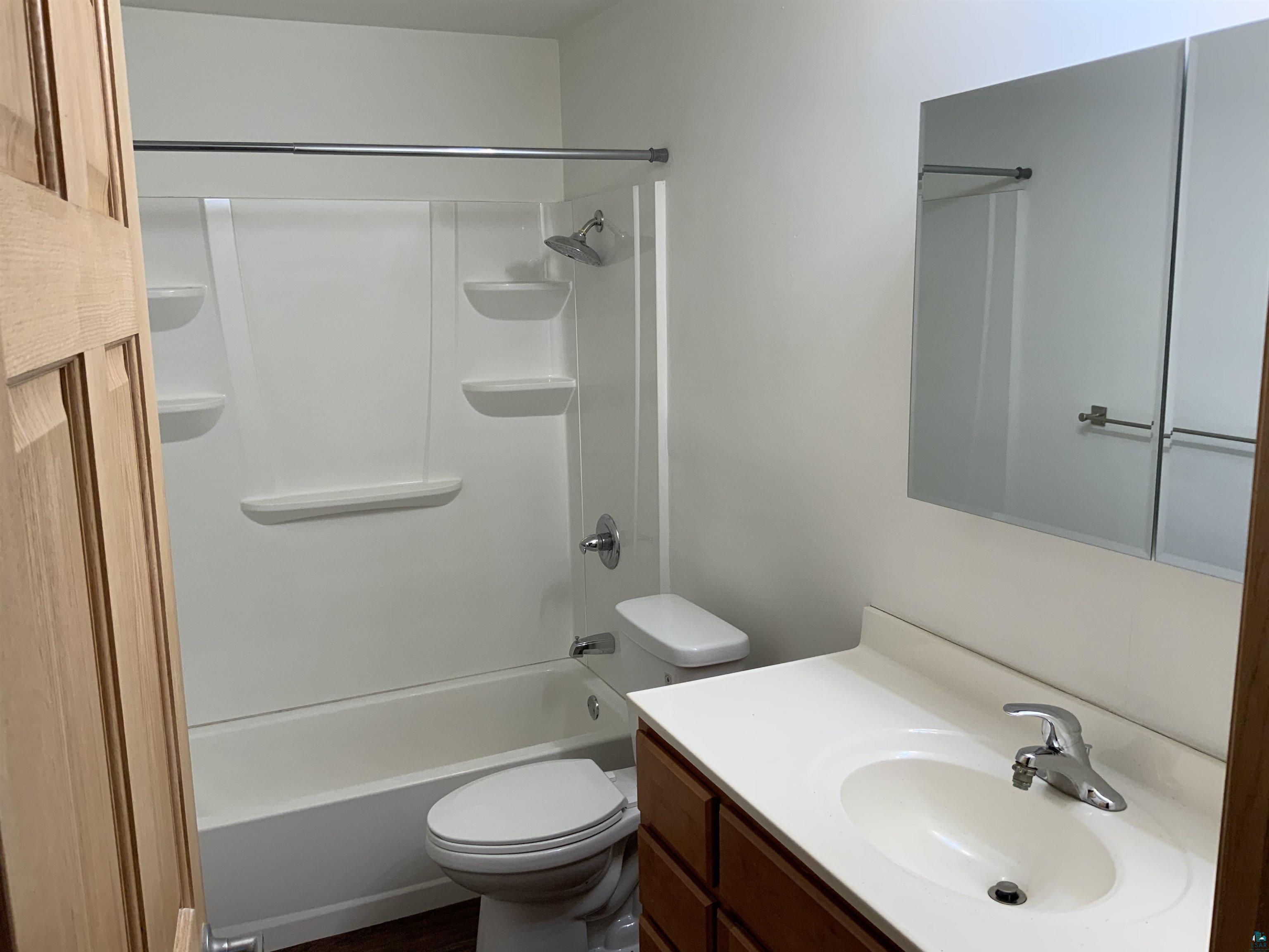 850 Spring Lake Road Cloquet, MN 55720 - Photo 18 of 18 Full bathroom with vanity, tub / shower combination, and toilet