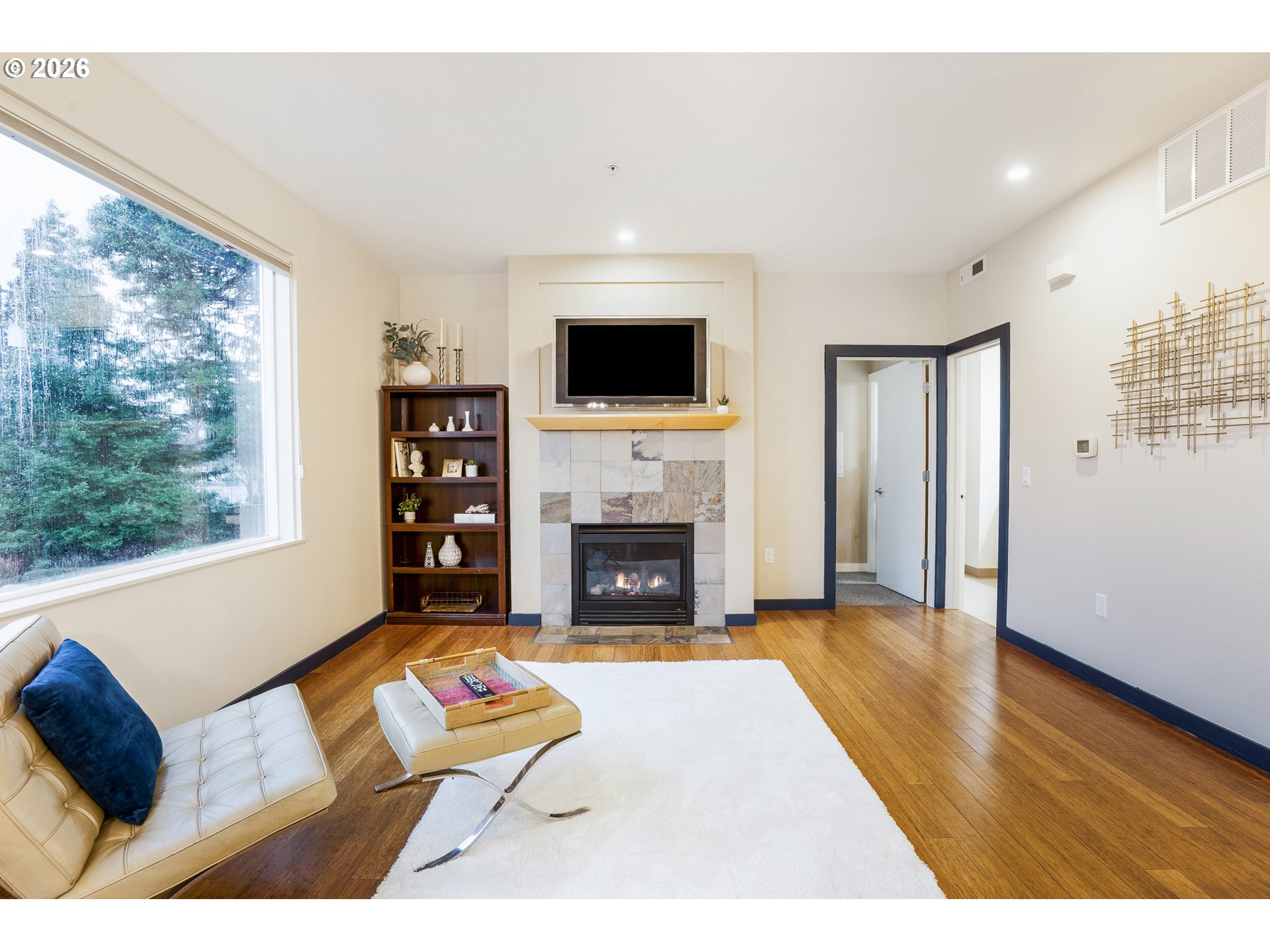 347 Rustic Place, Unit 14 Eugene, OR 97401 - Photo 6 of 20 a living room with furniture large window and a fireplace