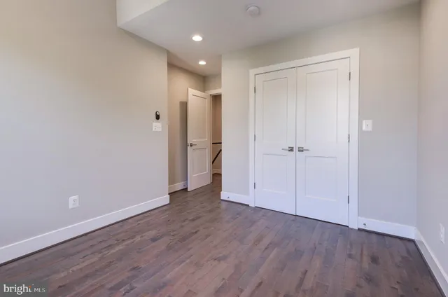a bathroom with a granite countertop shower sink vanity and toilet