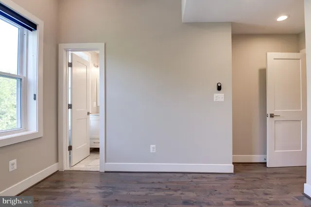 a bathroom with a sink a light fixture and a mirror